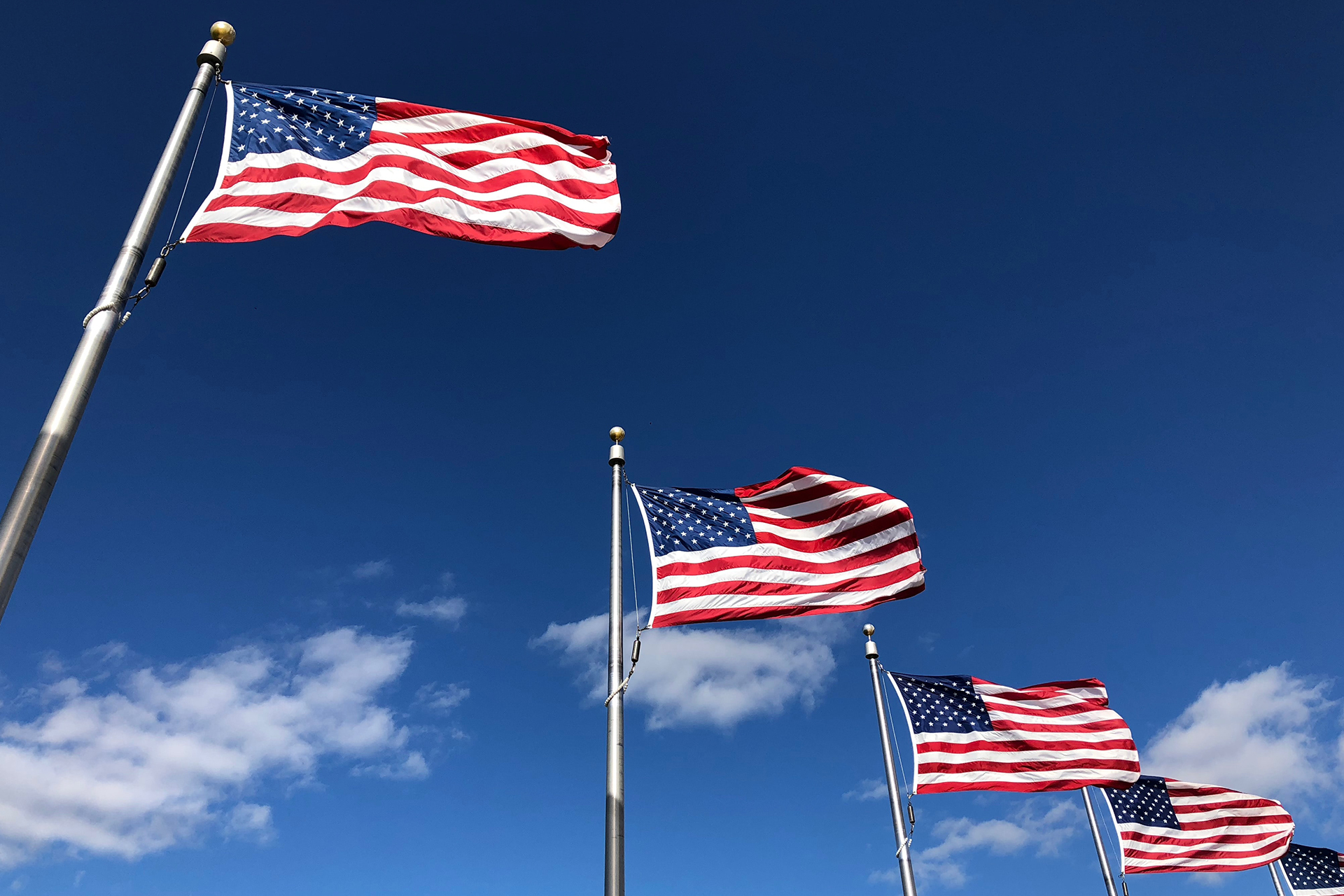 american flags under clear sky